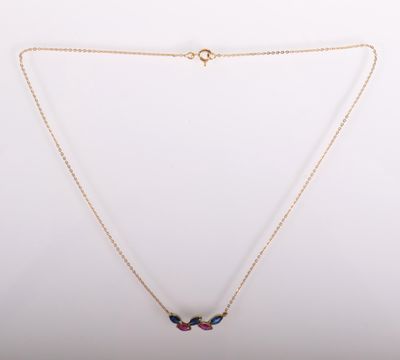 a gold necklace with a multi colored stone pendant on a chain