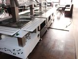 a kitchen with a stove, oven, and tables in it