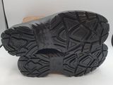 the soles of a pair of black hiking boots on a white surface