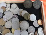 a wooden box filled with lots of coins on a table