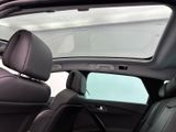 a view of a car ' s sunroof from the back seat