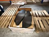two pairs of shoes in a box on a pallet