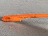 an orange toothbrush that is laying on a table