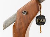 a close up of a knife with a tag on it