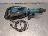 a close up of a drill on a table with a cord