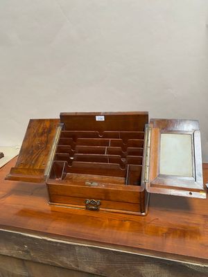 a small wooden box with a mirror on top of it