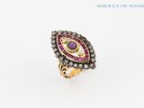 a close up of a ring with a purple stone in it