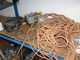 a pile of wires and other electrical equipment on a shelf