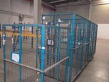 a large metal cage in the middle of a warehouse