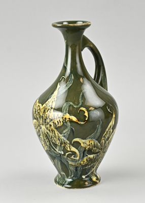 a green vase with a bird design on it