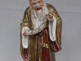 a figurine of a man with a white beard and a red robe