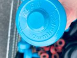 a person holding a blue water bottle in a shopping cart