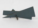 two pieces of metal on a white surface with a white background