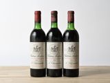 three bottles of wine sitting on top of a wooden table