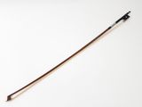 a close up of a violin bow on a white surface