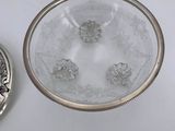 a silver plate and a silver spoon on a white table