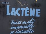 a sign that says lactene in french on the side of a building