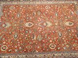 an orange rug with a floral design on it