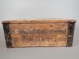 an old wooden box with writing on it sitting on a table