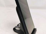a cell phone that is sitting on top of a stand