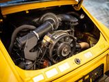 a yellow car with a turbo engine in the trunk