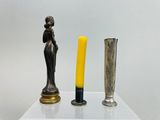 two vases and a candle on a white table