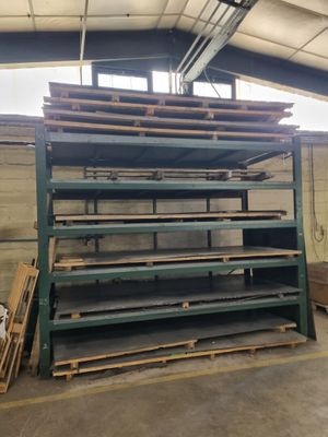 a large stack of shelves in a warehouse with lots of wood