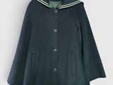 Le manteau est bleu et comporte une bande blanche au niveau du col.
