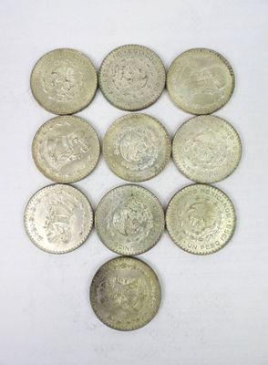 a close up of a bunch of coins sitting on top of a white surface