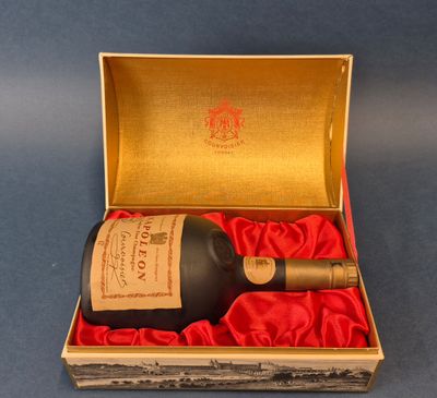 an open box with a bottle of wine in it on a blue surface
