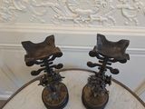 two metal chairs sitting on top of a marble table