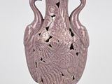 a purple vase that has a bird design on it