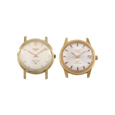 pair of gold tone wrist watches with white dials on a white background