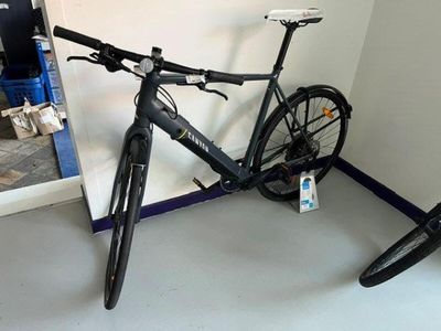 a bike that is leaning against a wall in a room