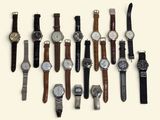 a lot of watches that are lined up on the table