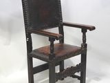 an old wooden chair with a brown leather seat on a white background