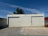 an image of a building with a garage in front of it