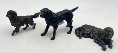 three figurines of dogs on a white surface