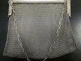 a silver metal mesh purse with chain and clasp