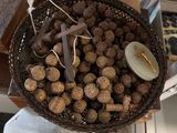 a basket full of nuts on a table with a cross
