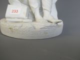 a statue of a man holding a suitcase and a dog