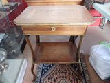 a small wooden table with a drawer on top of it