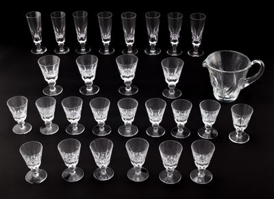 a lot of glasses and a pitcher on the table