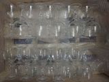 many empty wine glasses in a box on the table