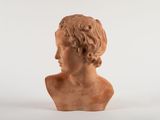 a close up of a clay bust of a man with curly hair