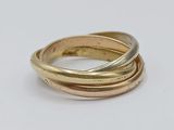 a close up of three different colored rings on a white surface