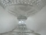 a clear glass bowl on a table with a white background
