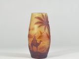 a vase with a picture of a man riding a camel