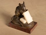 a statue of a mouse holding a piece of cheese