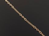 a close up of a gold bracelet on a black surface